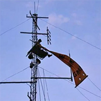 Scott Daines perched on a communications tower near James Price Point