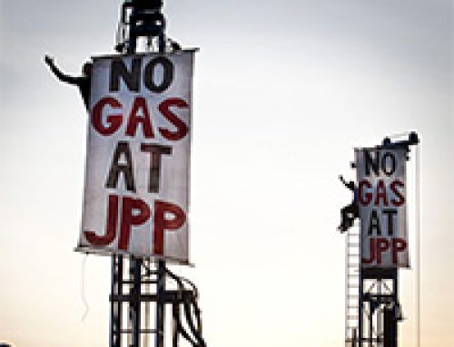 Protestors sitting atop two Woodside drill rigs